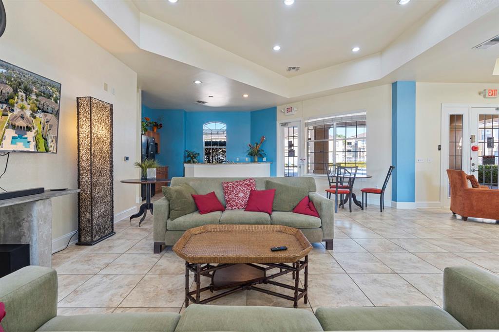 707 Terrace Ridge Circle, Unit 707 Davenport, FL 33896 - Photo 53 of 59 a living room with furniture and a table