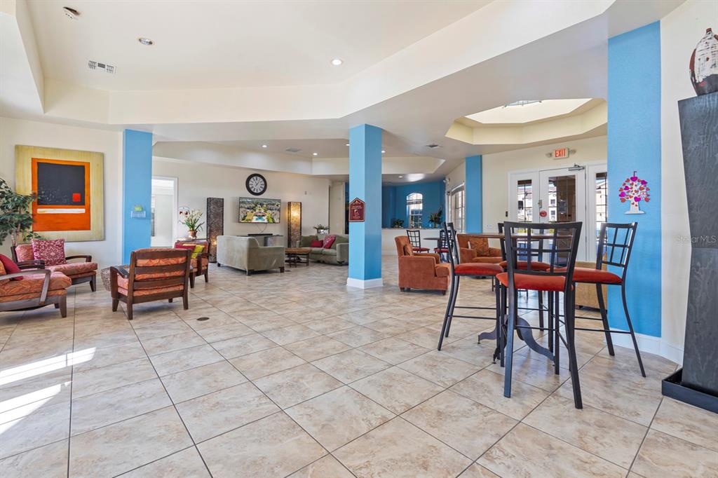 707 Terrace Ridge Circle, Unit 707 Davenport, FL 33896 - Photo 54 of 59 a living room with furniture and a dining table