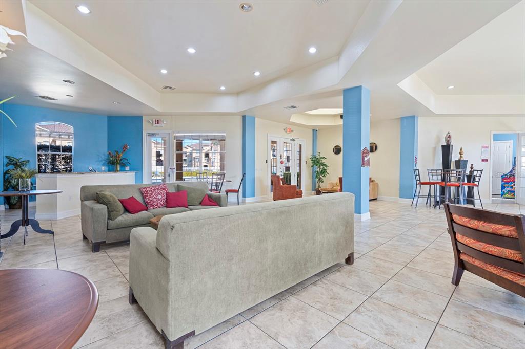 707 Terrace Ridge Circle, Unit 707 Davenport, FL 33896 - Photo 55 of 59 a living room with furniture and a large mirror