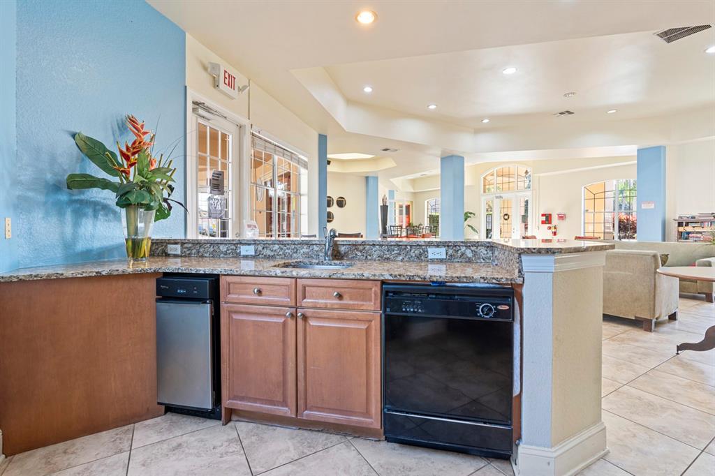 707 Terrace Ridge Circle, Unit 707 Davenport, FL 33896 - Photo 57 of 59 a kitchen with stainless steel appliances granite countertop a sink and a stove