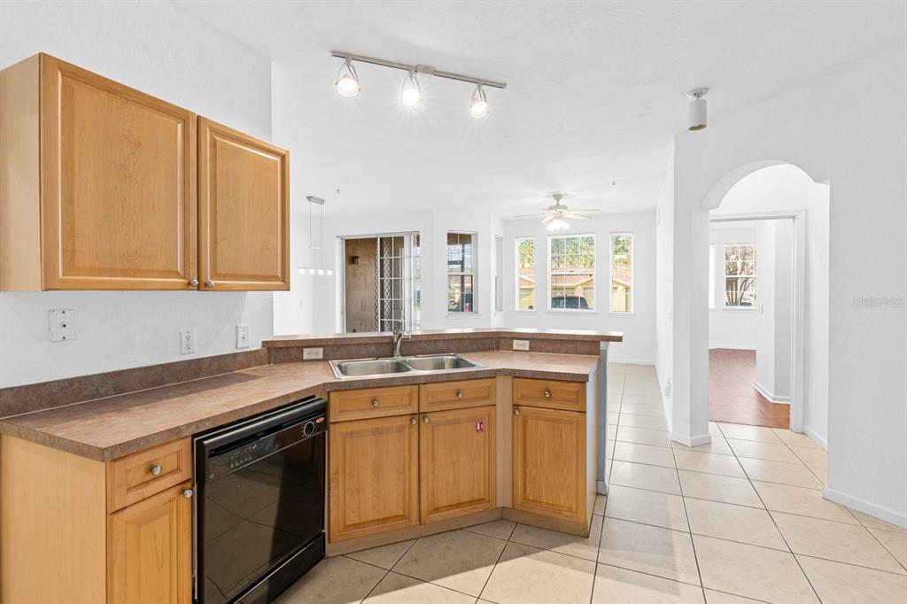 707 Terrace Ridge Circle, Unit 707 Davenport, FL 33896 - Photo 6 of 59 a kitchen with a sink stove and cabinets