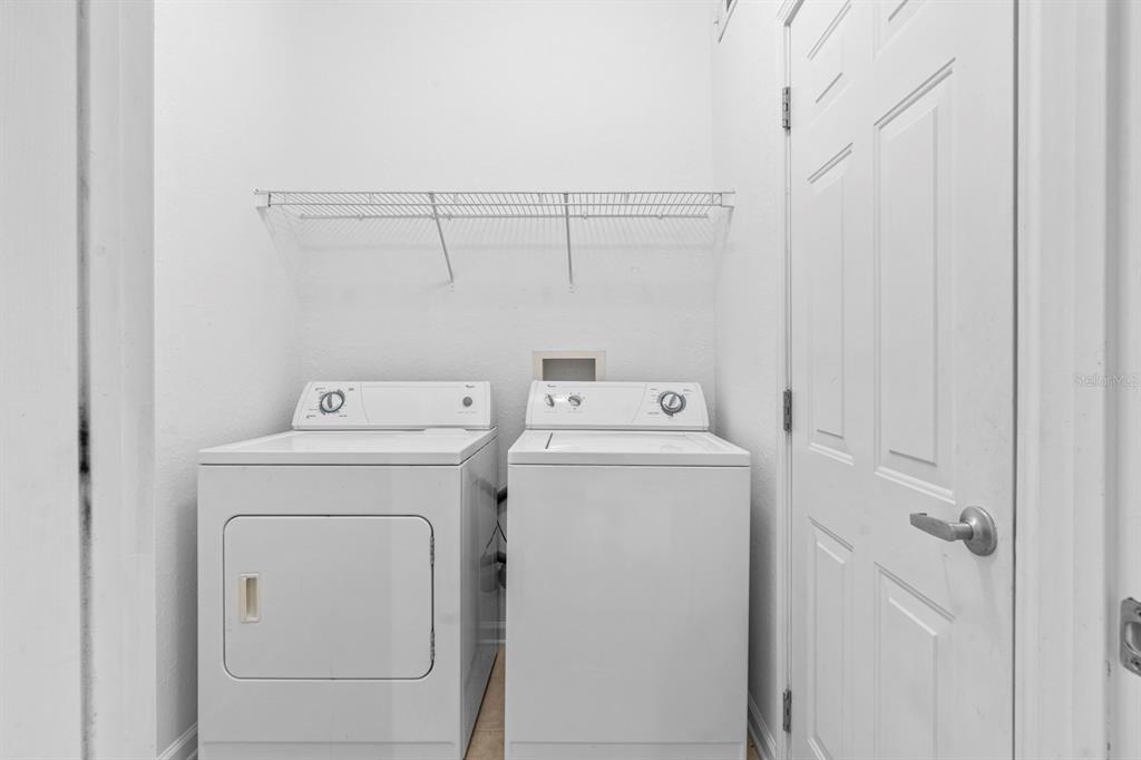 707 Terrace Ridge Circle, Unit 707 Davenport, FL 33896 - Photo 10 of 59 a utility room with dryer and washer