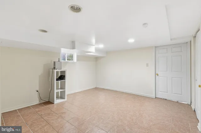 an empty room with a empty space and windows