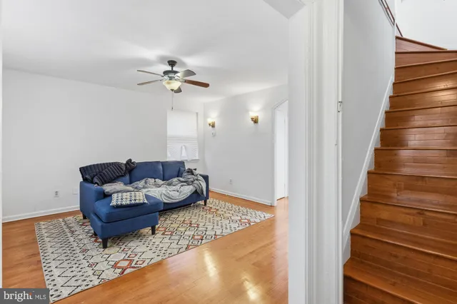 a living room with furniture and a stair