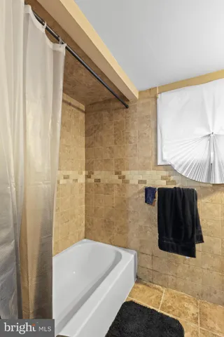 a bathroom with a shower and a tub