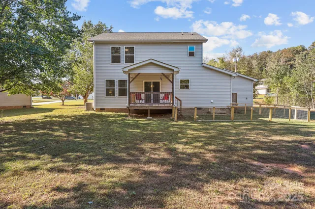 a view of deck with furniture and garden