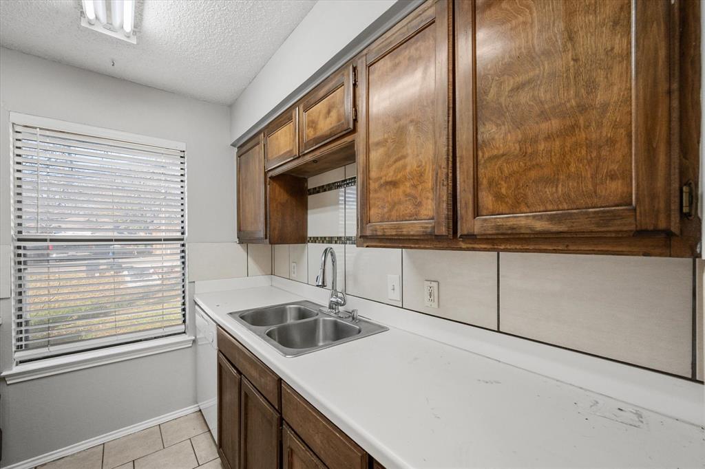 5821 Mansfield Road Arlington, TX 76017 - Photo 10 of 24 a bathroom with a sink and a mirror