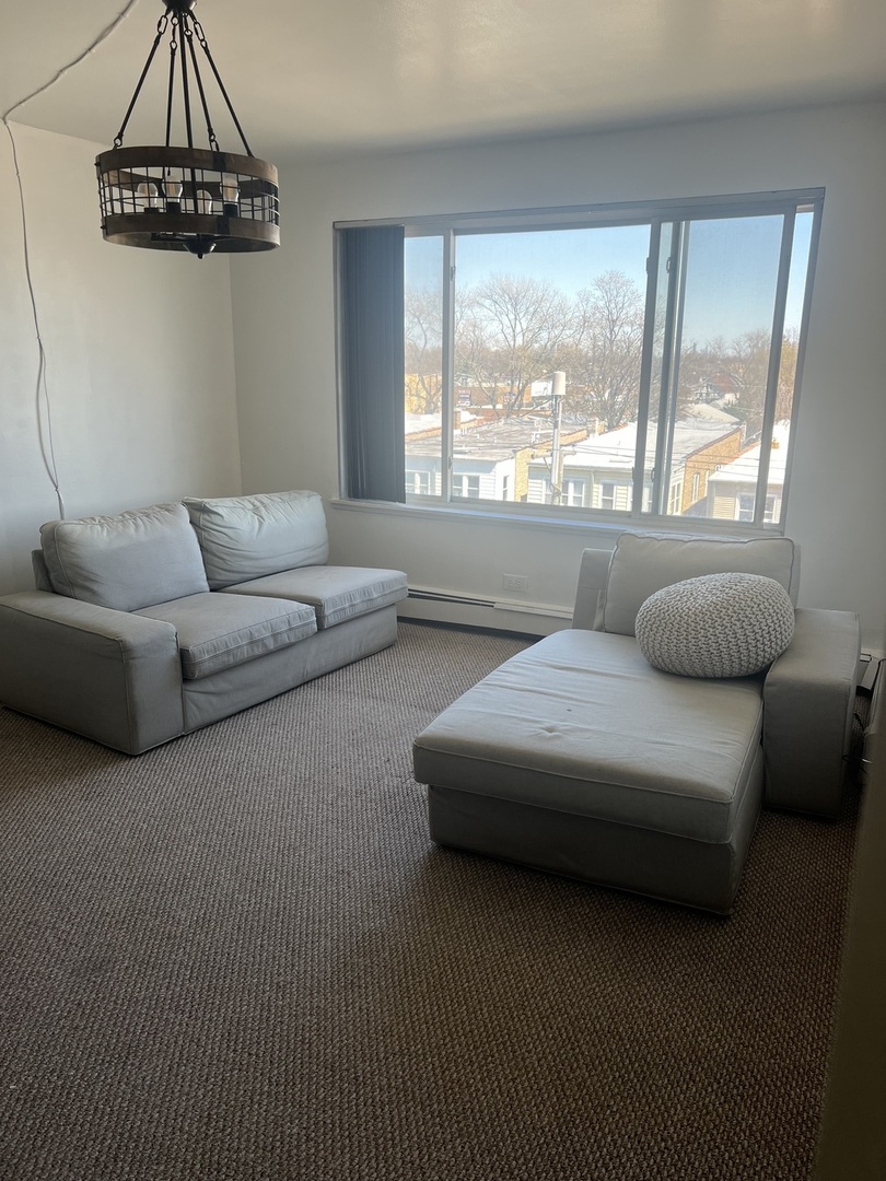 1227 South Harlem Avenue, Unit 512 Berwyn, IL 60402 - Photo 12 of 28 a living room with furniture and a window