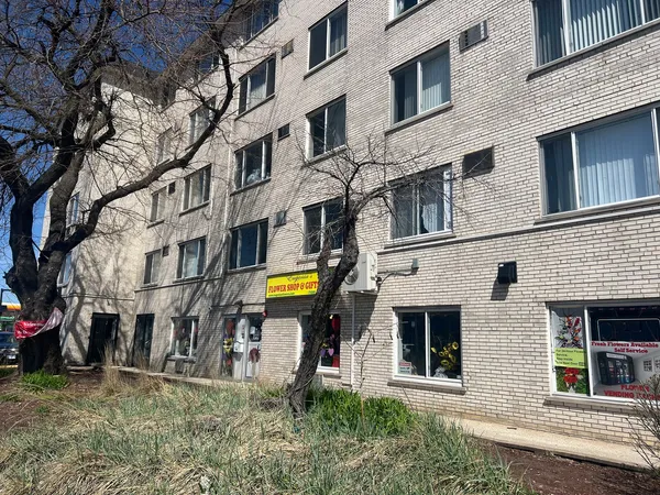 a front view of a building with a garden