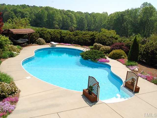 4305 Irene Way Raleigh, NC 27603 - Photo 9 of 12 The view from your back deck! Gorgeously landscaped in-ground pool is the crown jewel of the nearly 2-acre lot. Swimming Pool/Hot Tub/Sauna