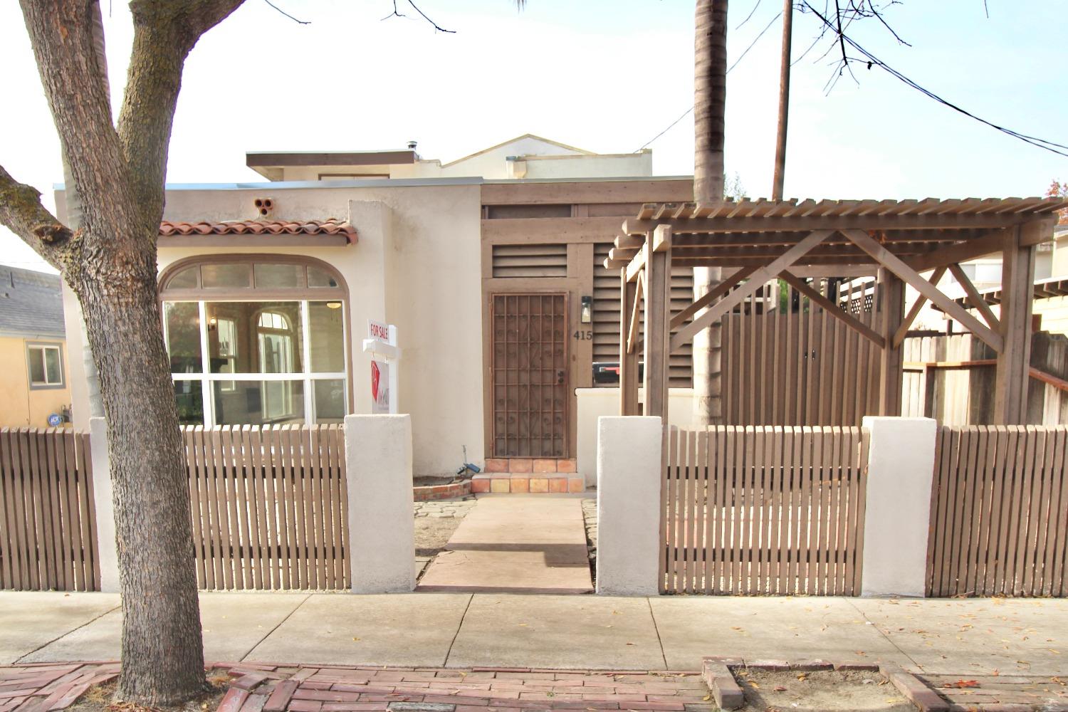 a view of a brick house with large windows