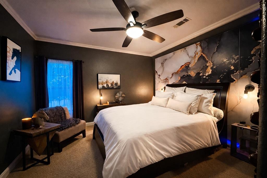 1919 Kings Pass Heath, TX 75032 - Photo 24 of 38 This inviting room features a modern ceiling fan, dark walls, and a distinctive accent wall with a marble-effect design