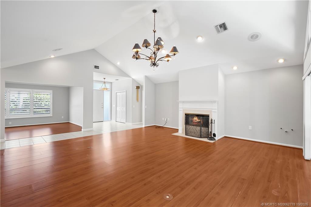 101 South Sewalls Point Road Stuart, FL 34996 - Photo 12 of 41 a view of a livingroom with a fireplace wooden floor and chandelier