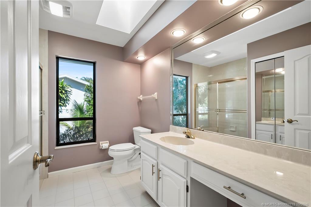 101 South Sewalls Point Road Stuart, FL 34996 - Photo 17 of 41 a bathroom with a double vanity sink toilet and shower
