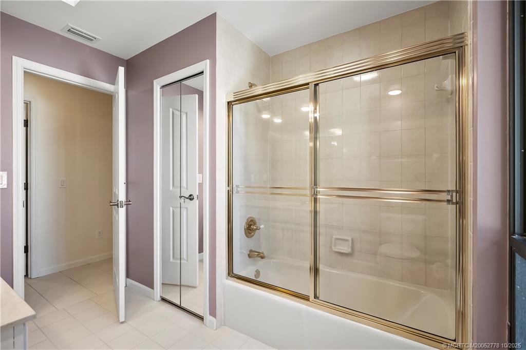 101 South Sewalls Point Road Stuart, FL 34996 - Photo 18 of 41 a bathroom with a glass shower door