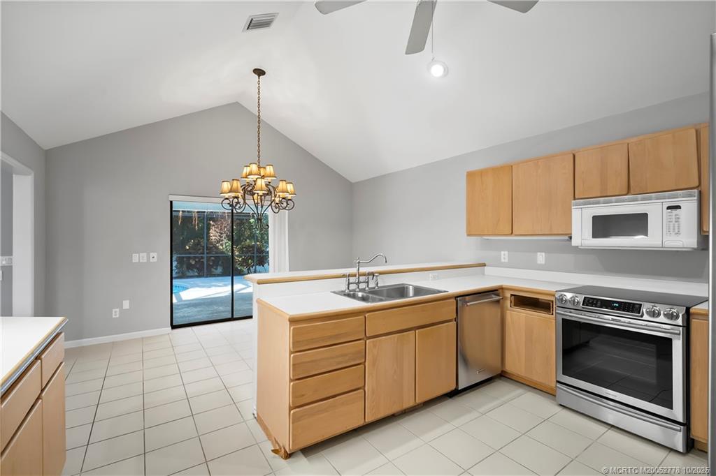 101 South Sewalls Point Road Stuart, FL 34996 - Photo 21 of 41 a kitchen that has a sink and a stove in it