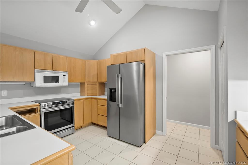 101 South Sewalls Point Road Stuart, FL 34996 - Photo 22 of 41 a kitchen with stainless steel appliances granite countertop a refrigerator a stove and a sink