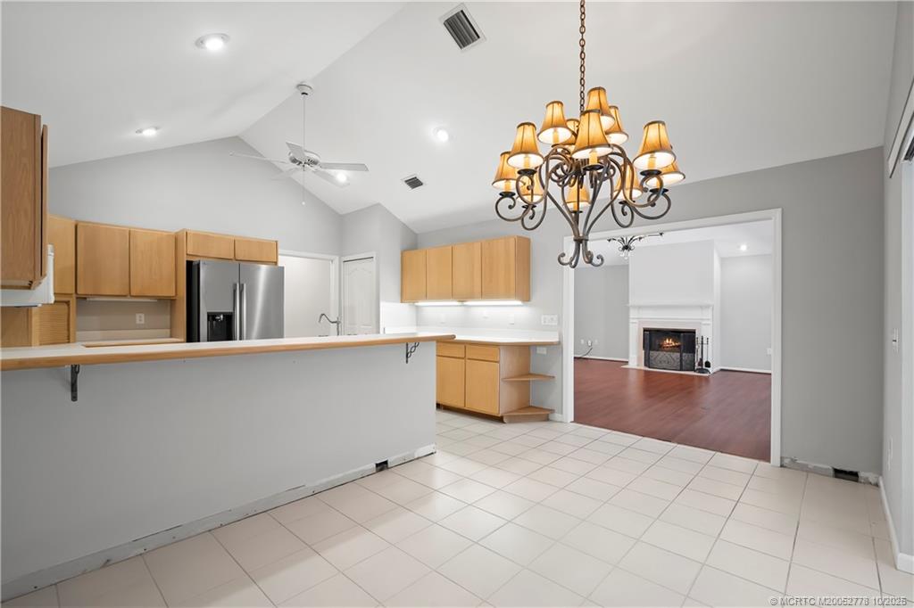 101 South Sewalls Point Road Stuart, FL 34996 - Photo 25 of 41 a kitchen with stainless steel appliances granite countertop a stove a sink and a chandelier