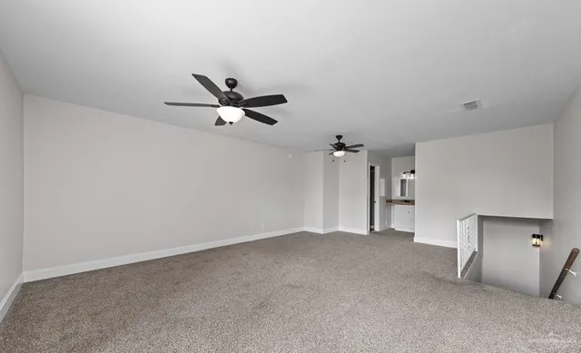 a view of a livingroom with a ceiling fan and window