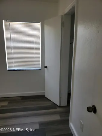 a view of a room with a wooden floor and a window