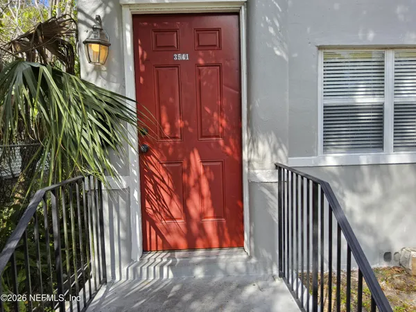 a view of a porch with a door and a window