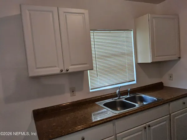 a kitchen with a sink and cabinets