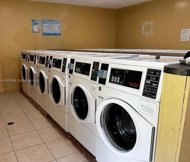 4431 Treehouse Lane, Unit H Tamarac, FL 33319 - Photo 5 of 10 a utility room with dryer and washer