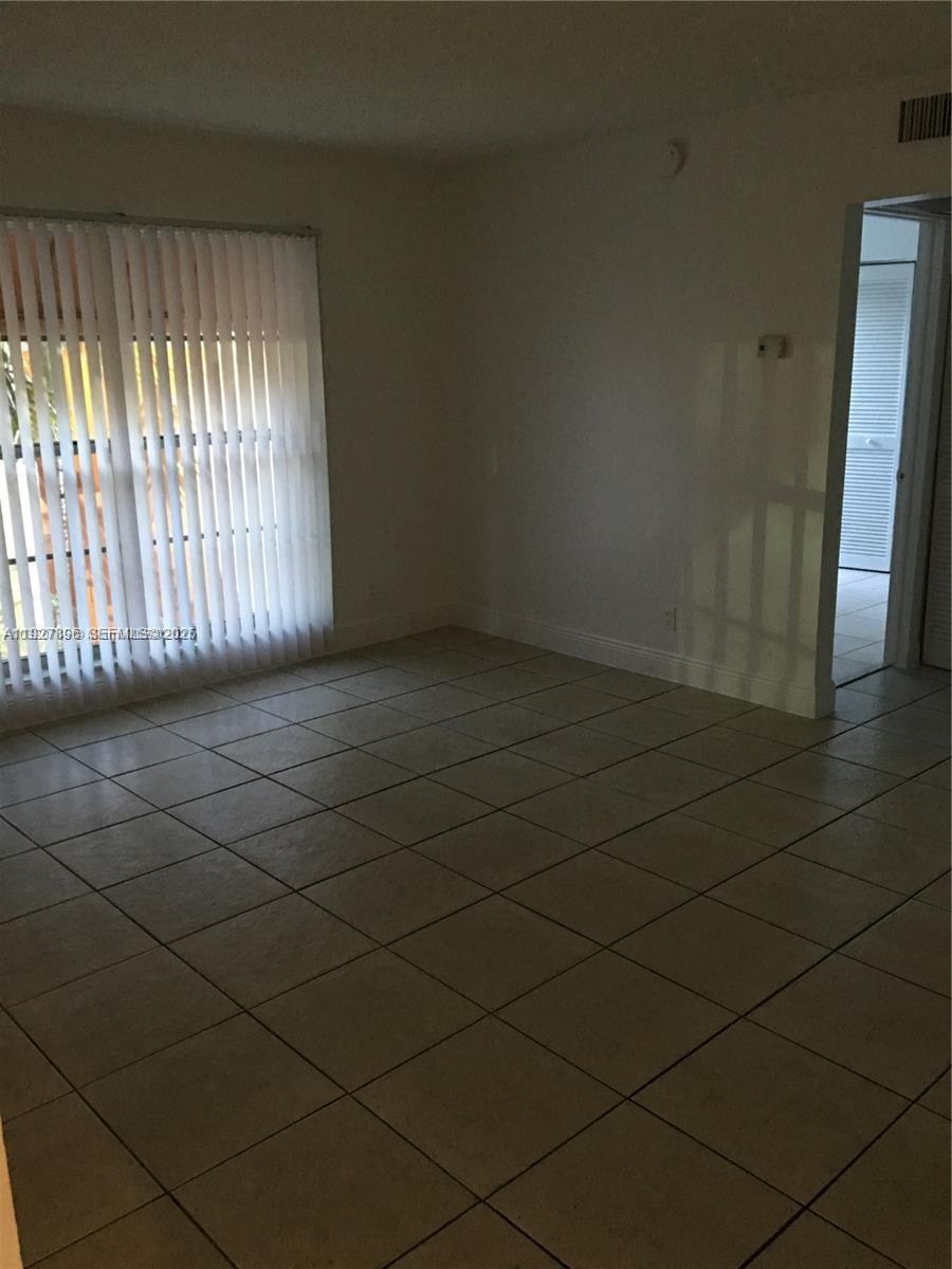 4431 Treehouse Lane, Unit H Tamarac, FL 33319 - Photo 6 of 10 en empty room with windows