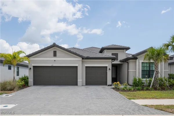a front view of a house with a yard and garage