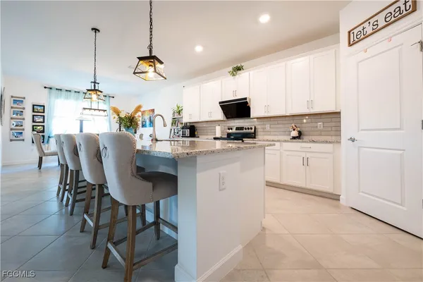 a kitchen with a sink cabinets and window