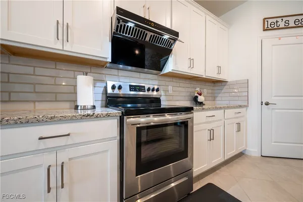 a kitchen with appliances cabinets and a counter top space