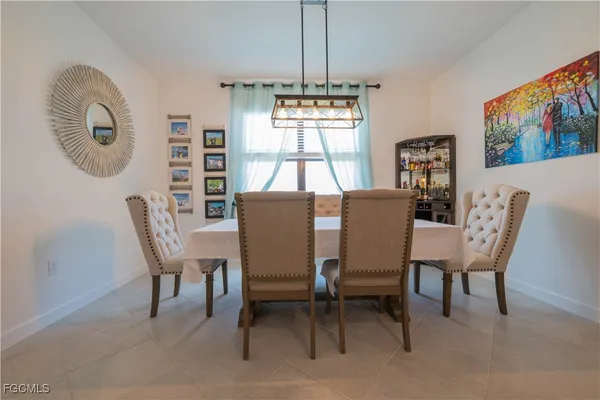 a dining room with furniture and window