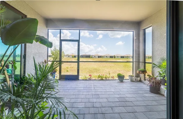 a view of a living room and floor to ceiling windows