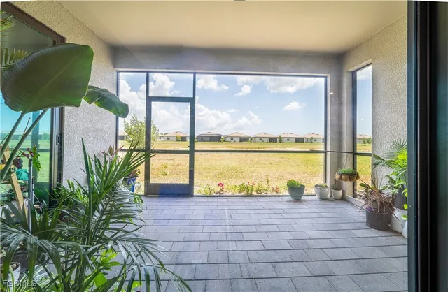 a view of a living room and floor to ceiling windows