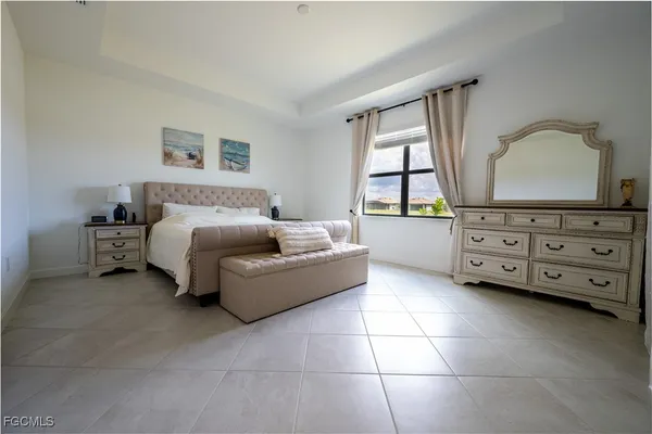 a spacious bedroom with a bed and window