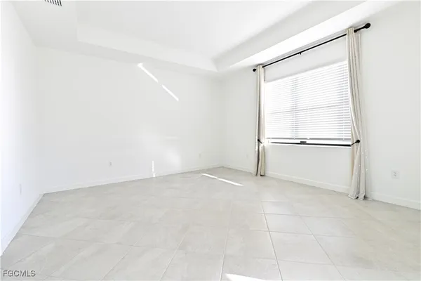 an empty room with a empty space and windows