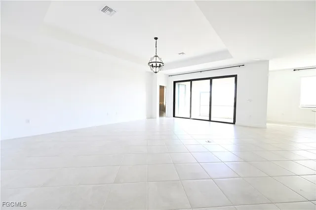 a view of an empty room with glass door