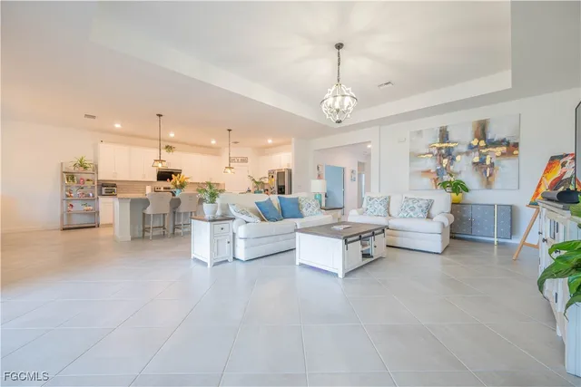 a living room with furniture and a chandelier