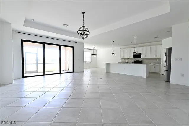 a view of a kitchen with a sink and a window