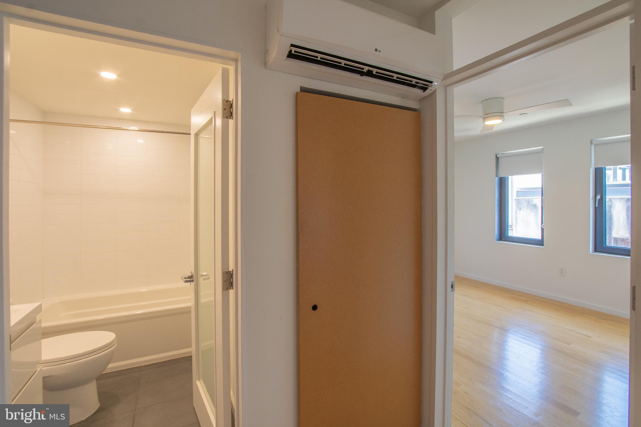 152 West Laurel Street, Unit 303 Philadelphia, PA 19123 - Photo 13 of 36 a bathroom with a granite countertop sink a toilet and shower