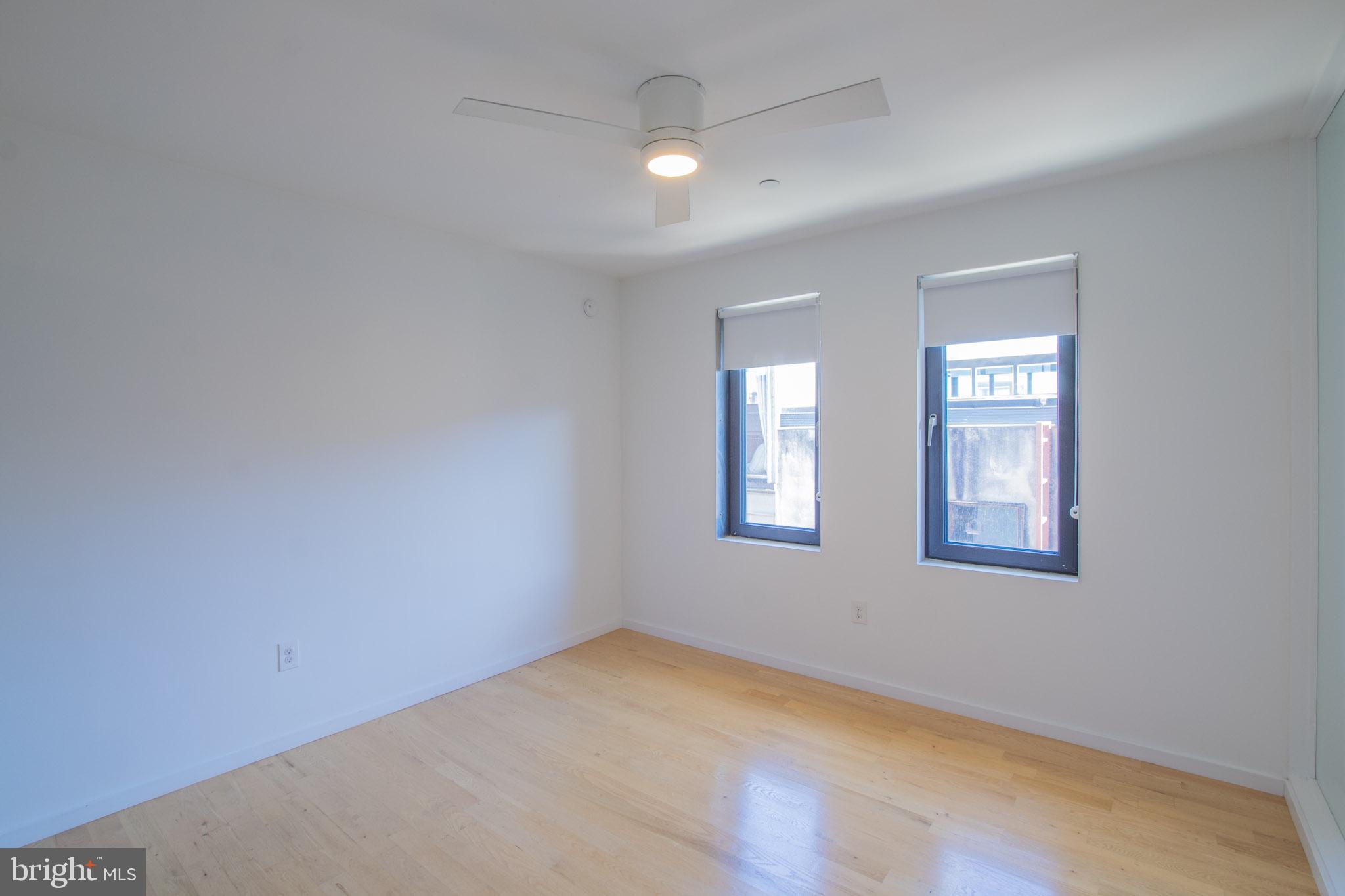 152 West Laurel Street, Unit 303 Philadelphia, PA 19123 - Photo 16 of 36 an empty room with windows and fan