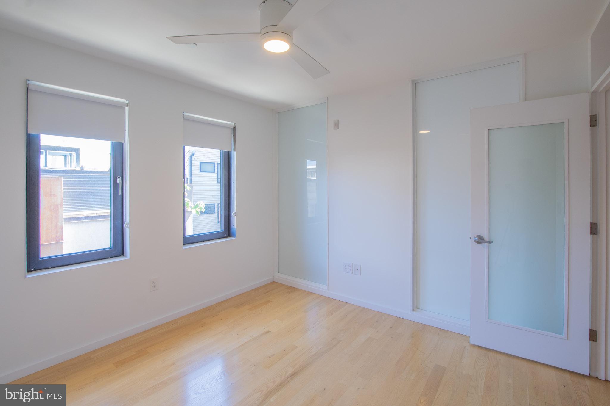 152 West Laurel Street, Unit 303 Philadelphia, PA 19123 - Photo 17 of 36 a view of an empty room with window and wooden floor