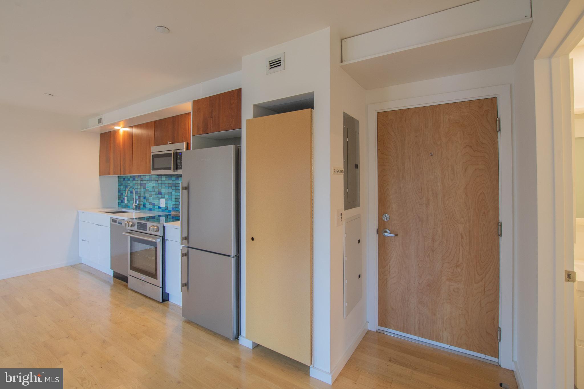 152 West Laurel Street, Unit 303 Philadelphia, PA 19123 - Photo 20 of 36 a kitchen with a refrigerator and a stove top oven