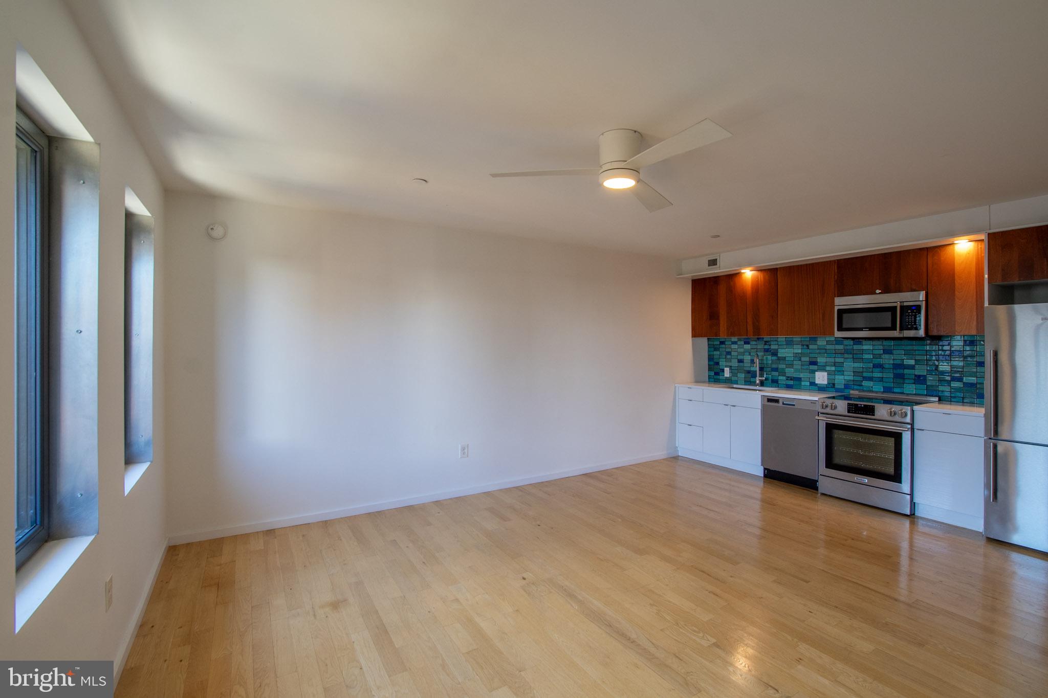 152 West Laurel Street, Unit 303 Philadelphia, PA 19123 - Photo 5 of 36 a view of kitchen and kitchen with stainless steel appliances wooden floor