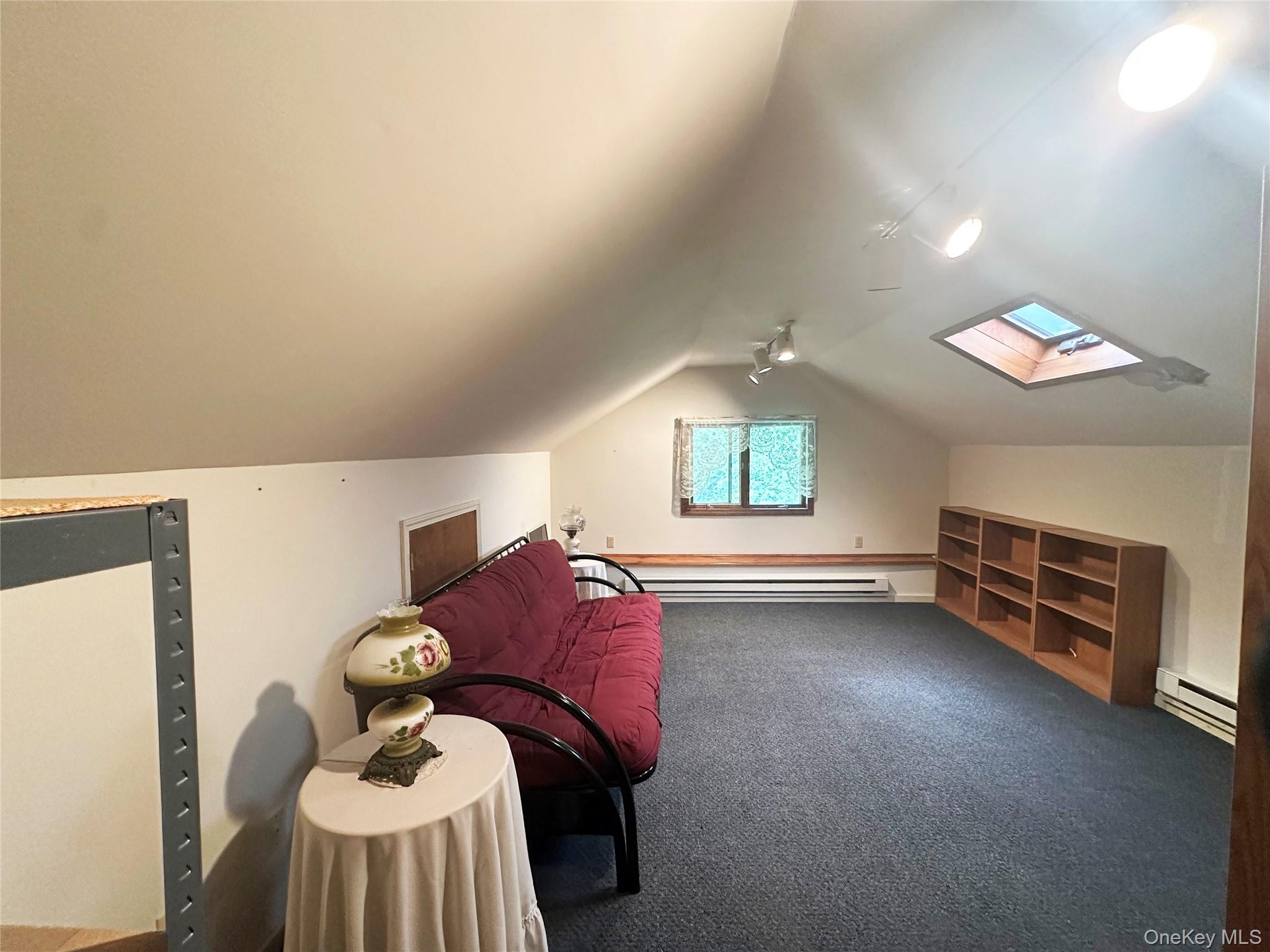 818 Methol Road Roscoe, NY 12776 - Photo 34 of 39 Finished upper-level loft/flex space with skylight, built-in shelving, and potential for office, recreation, or guest overflow use.