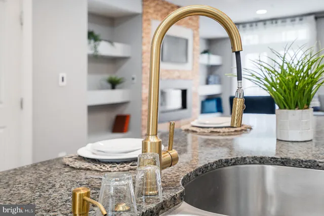 a kitchen with stainless steel appliances kitchen island granite countertop a stove and a sink