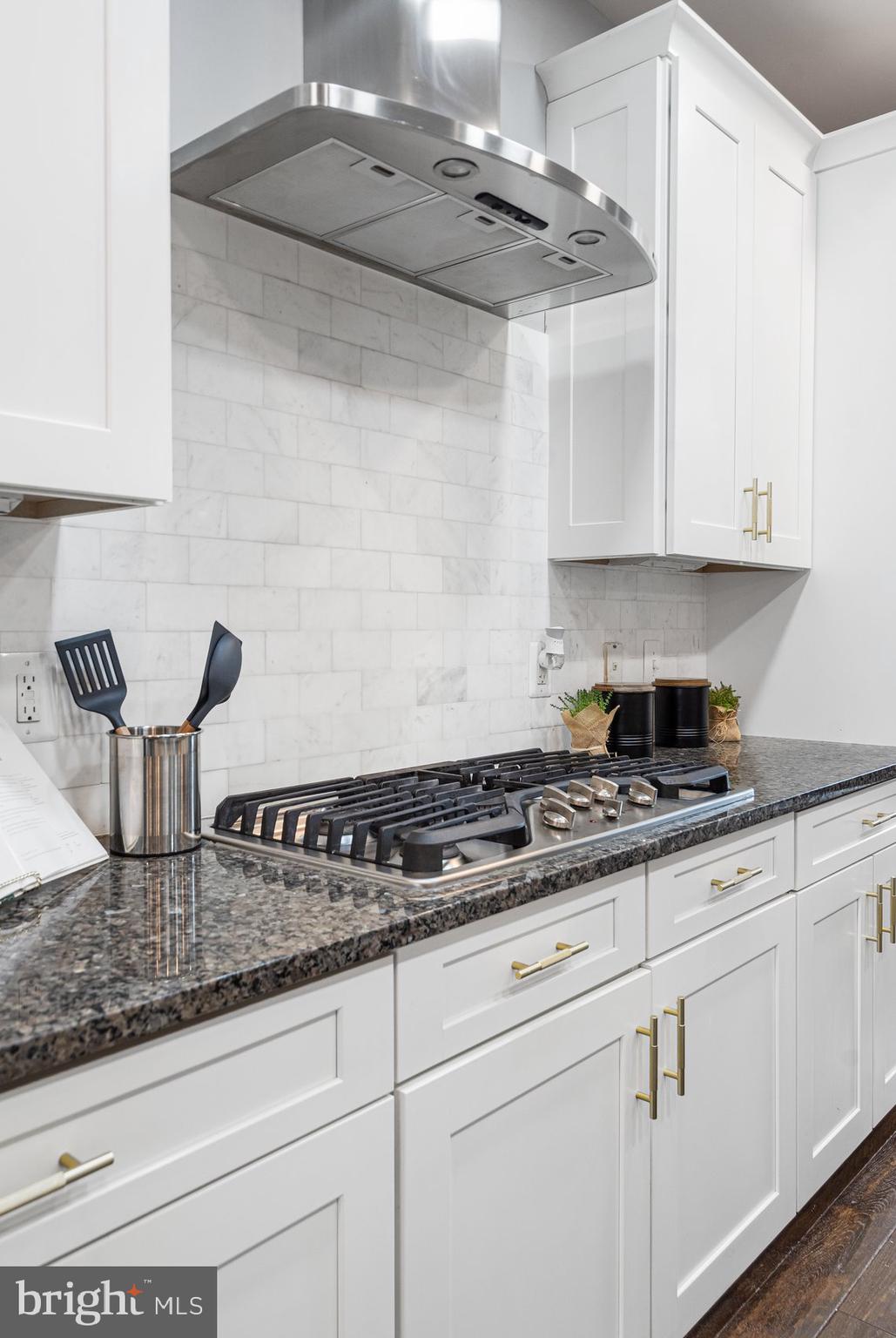 7429 Matapan Drive Hanover, MD 21076 - Photo 15 of 37 a kitchen with stainless steel appliances granite countertop a sink a stove and white cabinets