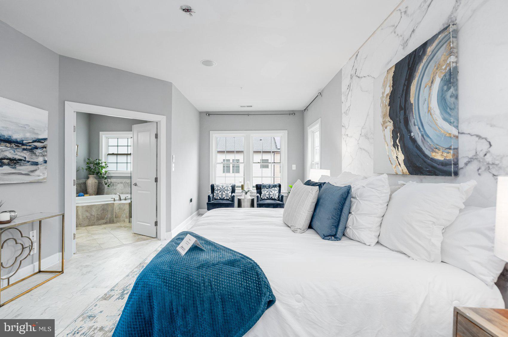 7429 Matapan Drive Hanover, MD 21076 - Photo 18 of 37 a bedroom with a large bed and a painting on the wall