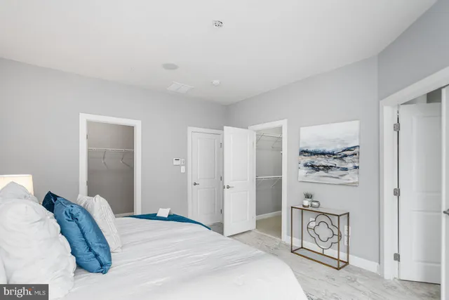 a white bath tub sitting next to a shower