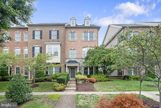 a front view of a house with a yard and porch